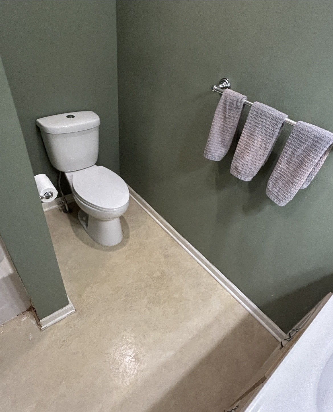 Before bathroom flooring and trim around toilet area.