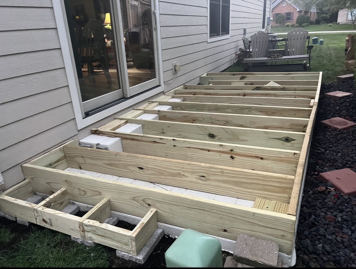 Ground-level deck framing from sliding door.